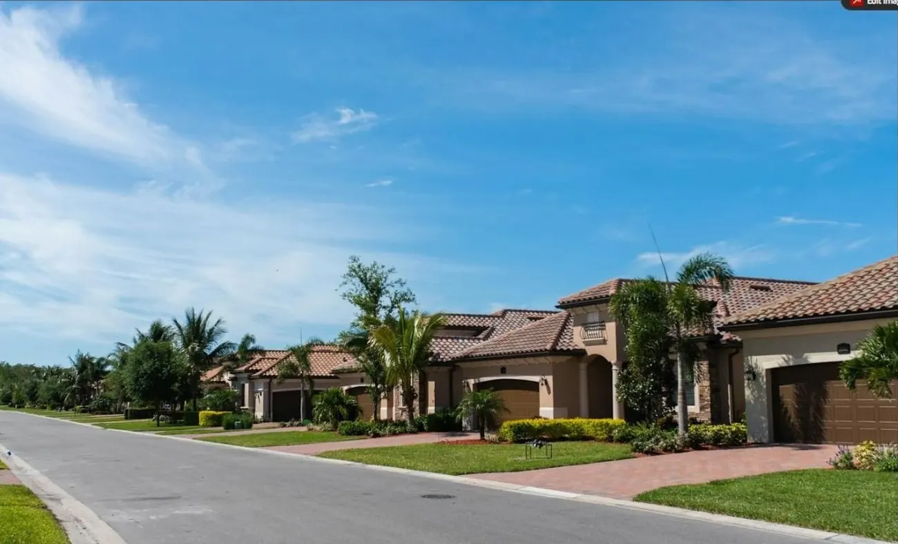 Street of Mediterranean-style single-family homes with tile roofs and palms, typical of newer Miami-Dade subdivisions
