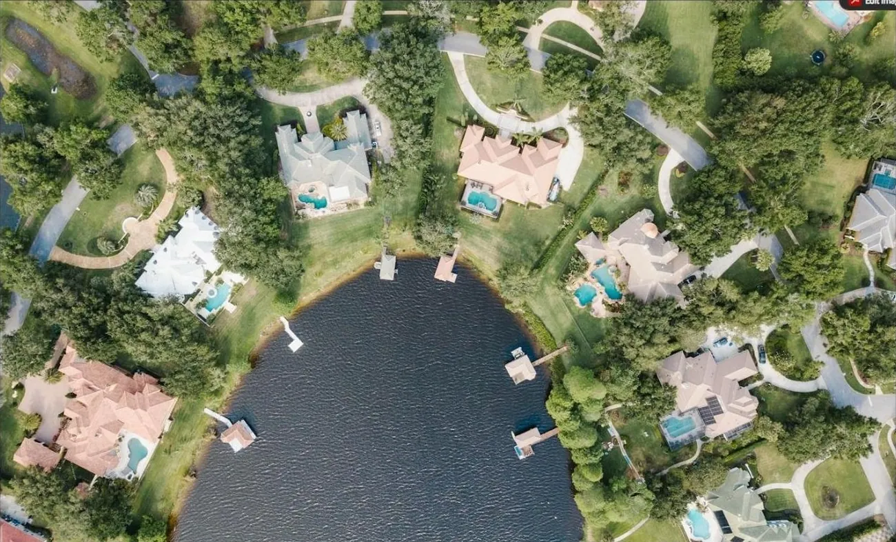 Aerial view of lakefront homes with pools in a master-planned Broward community
